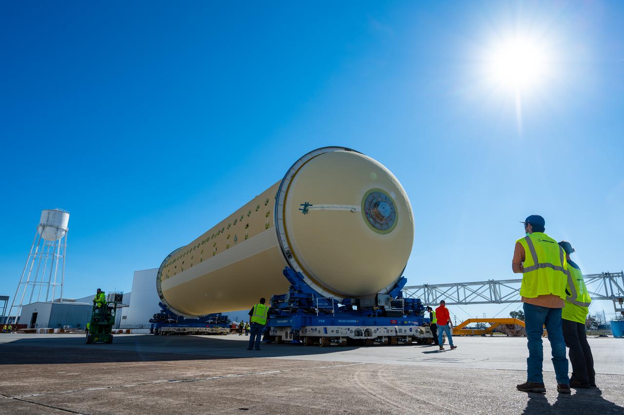 Technicians transported the assembled upper part of the Artemis II core stage to the final assembly area inside the factory at NASA’s Michoud Assembly Facility in New Orleans. On Jan 10, the forward assembly, left was moved next to the Artemis II liquid hydrogen tank, which has been undergoing assembly. Next, Boeing, the lead core stage contractor, will join the forward assembly and the liquid hydrogen tank to complete most of the core stage for the Space Launch System (SLS) rocket that will send the first crew on an Artemis mission. The core stage consists of five major structures that are built, outfitted, and then connected to form the final stage. The forward skirt, liquid oxygen and intertank were connected and tested to form the 66-foot forward assembly. After the forward assembly is joined with the 130-foot liquid hydrogen tank, only the engine section, the fifth piece of the stage, will need to be added to complete the Artemis II core stage. The core stage serves as the backbone of the rocket, supporting the weight of the payload, upper stage, and crew vehicle, as well as the thrust of its four RS-25 engines and two five-segment solid rocket boosters attached to the engine and intertank sections. On Artemis II, the SLS rocket will launch the Orion spacecraft and a crew, sending them into lunar orbit, in preparation for later Artemis missions that will enable the first woman and first person of color to land on the Moon.